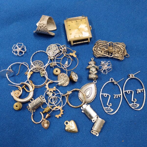 Tray of vintage silver-tone jewellery including earrings and pendants.