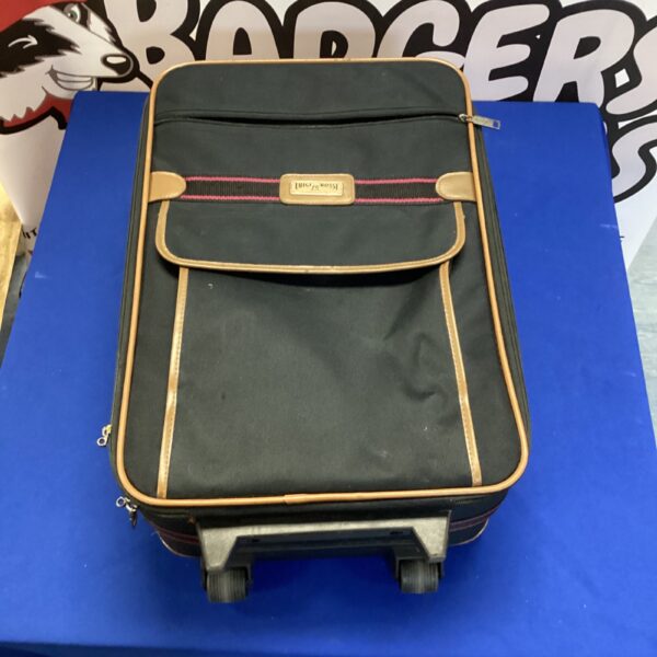 Vintage Luigi Ross rolling suitcase with a hard shell.
