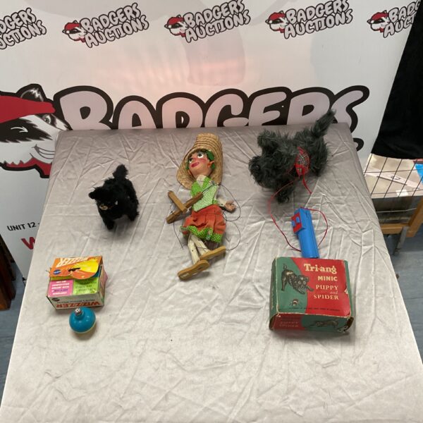 Vintage toy lot featuring a wooden puppet and tinplate spider.