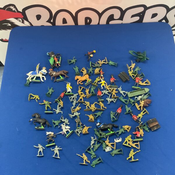 Vintage toy soldier figures and horses in a collectible lot.