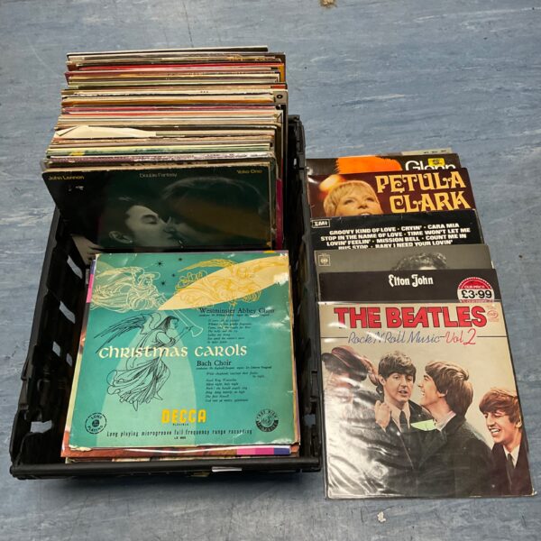 Vintage vinyl record collection featuring Beatles and John Lennon records.