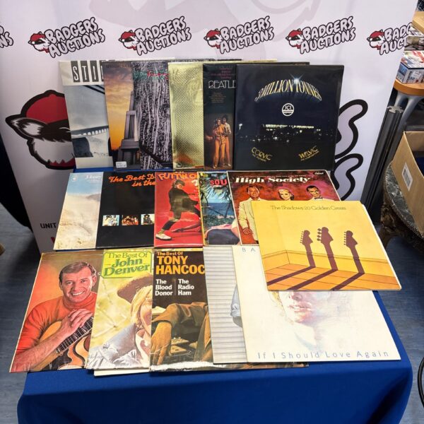 Diverse vinyl record collection lot with Beatles album visible.