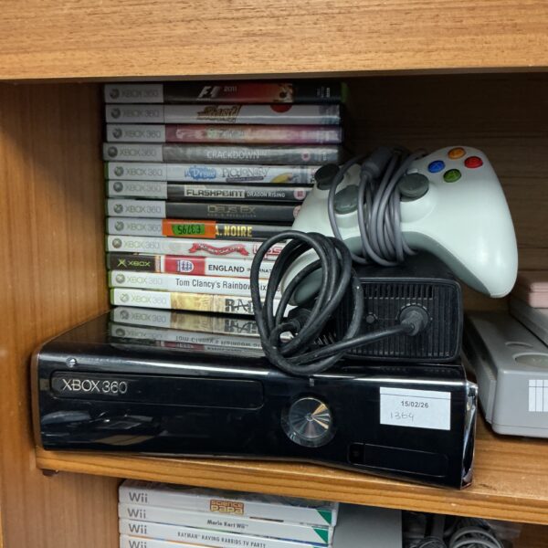 Microsoft Xbox 360 console with controllers and games displayed.