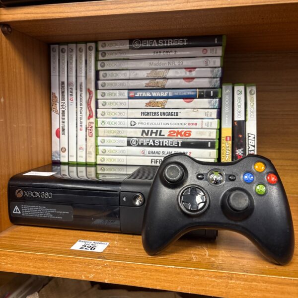 Xbox 360 E console with games and controller in a lot.