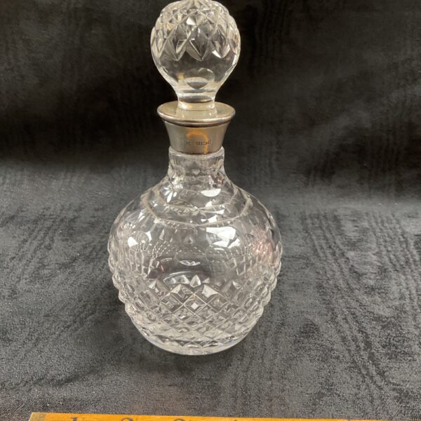 Antique crystal decanter with hallmarked silver top, vintage glassware.