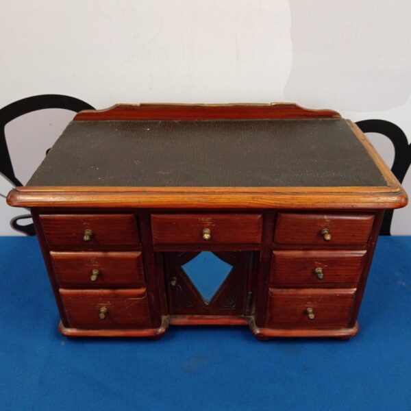 Antique miniature writing desk with three drawers, a collectible item.