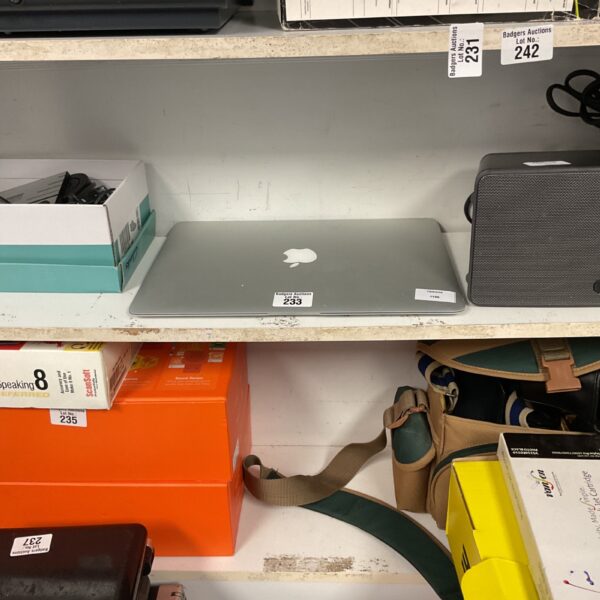 Silver Apple MacBook laptop computer presented for auction.