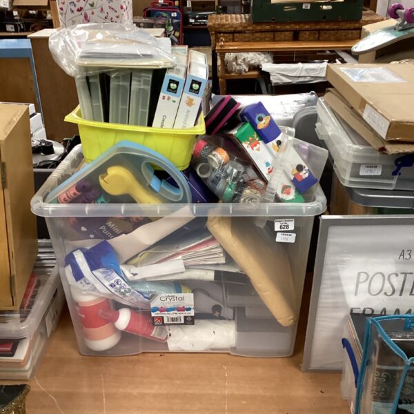 Clear plastic storage box filled with arts and crafts supplies.