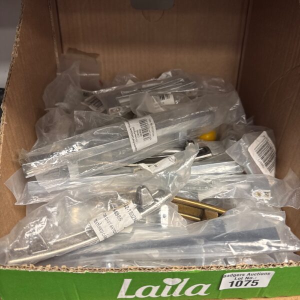 Assorted new drawer and cupboard handles in a cardboard box.