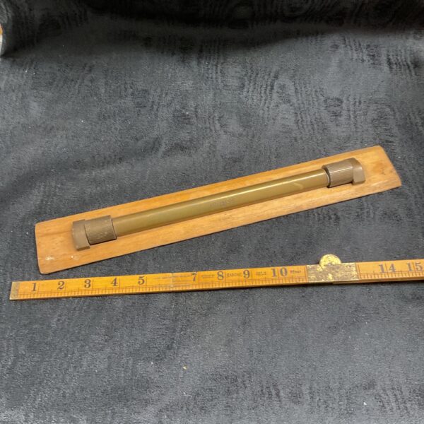 Vintage Astonmander brass table map roller for navigation.