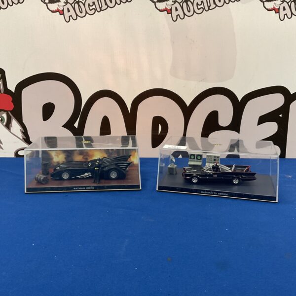 Two Batmobile models from the Batman movie and series on display.