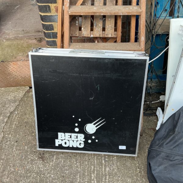 Close-up of a well-used beer pong table with a laminated surface.