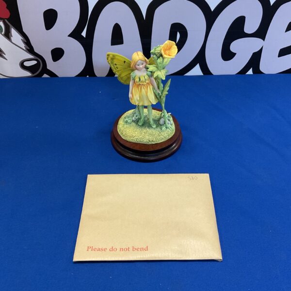Border Fine Arts Flower Fairy figurine on blue surface.