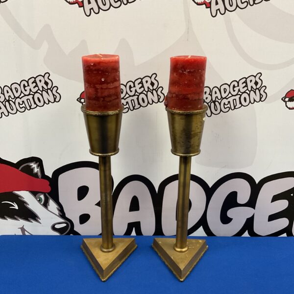 Vintage brass candlesticks with triangular bases for table decor.