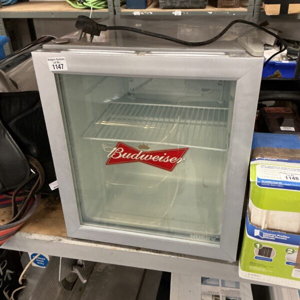 Front view of a vintage Budweiser beer fridge.