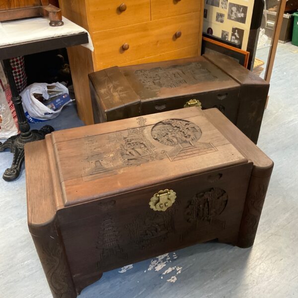 Intricately carved oriental camper chest with detailed landscape scenes.