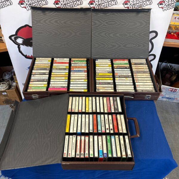 Vintage cassette tape cases filled with mixed audio tapes.