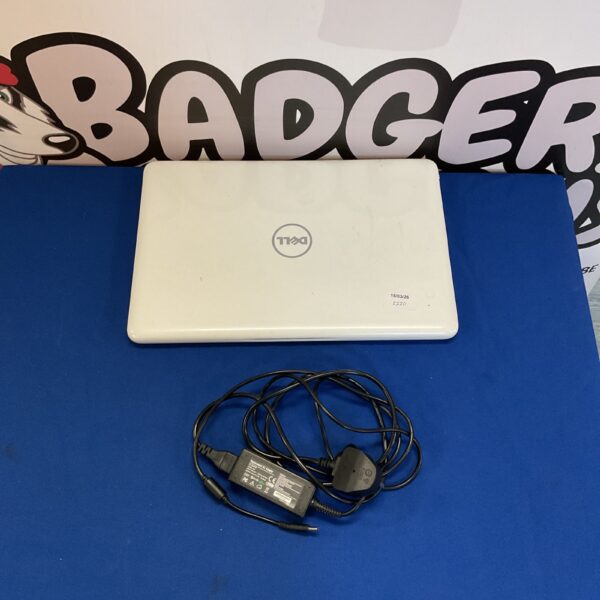 White Dell Inspiron laptop with charger, vintage computing.
