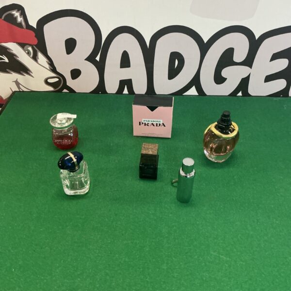 Collection of empty designer perfume bottles for display.