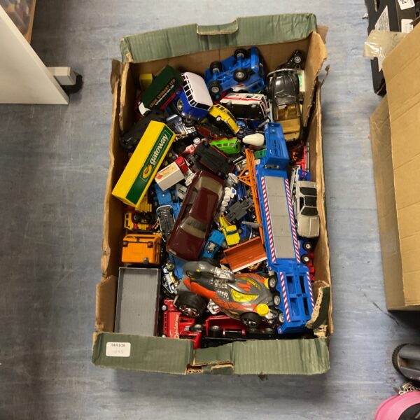 A box filled with a diverse lot of diecast model cars.