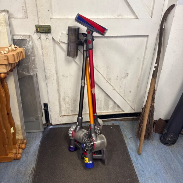 Lot of three Dyson cordless vacuum cleaners for sale.