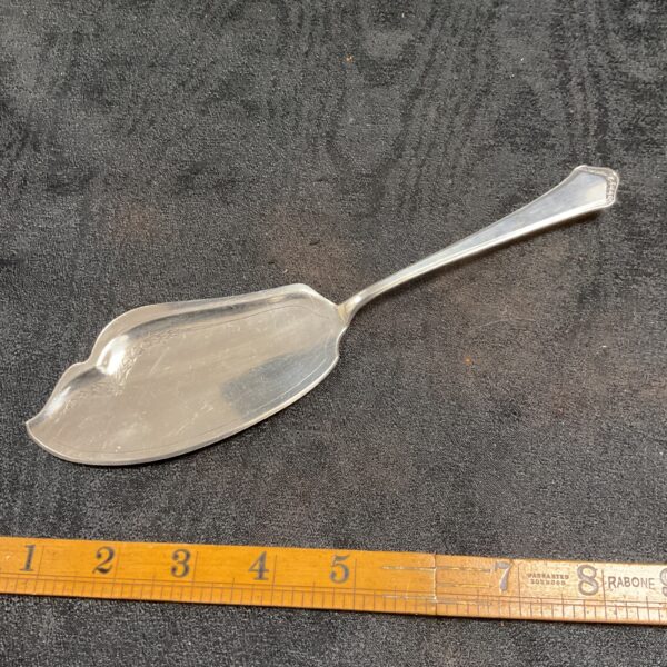 Antique German silver cake slice with embossed pattern.