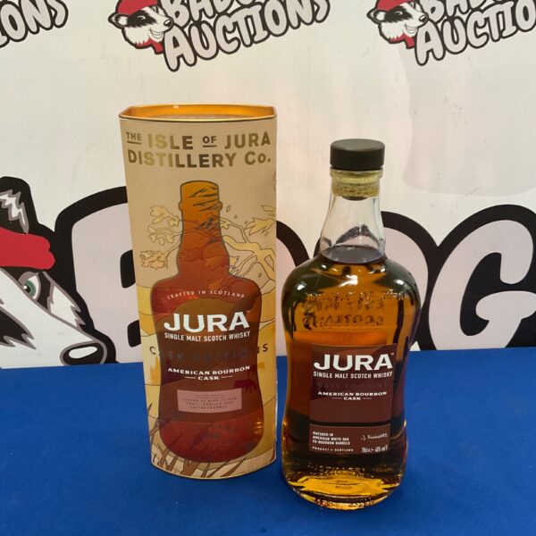 Sealed bottle of Jura Single Malt Scotch Whisky on a dark background.