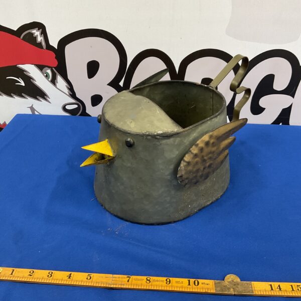 Vintage metal bird watering can for garden use.