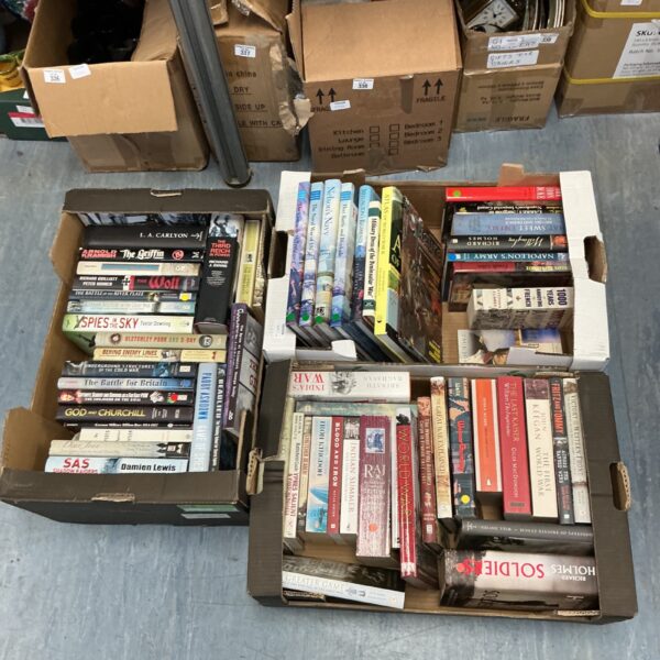 Three crates filled with vintage military history books for collectors.