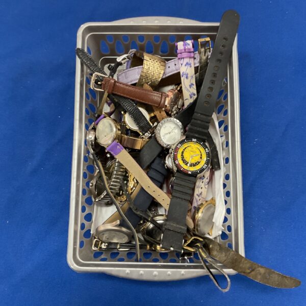 Tray of mixed vintage and modern wristwatches for repair or collection.