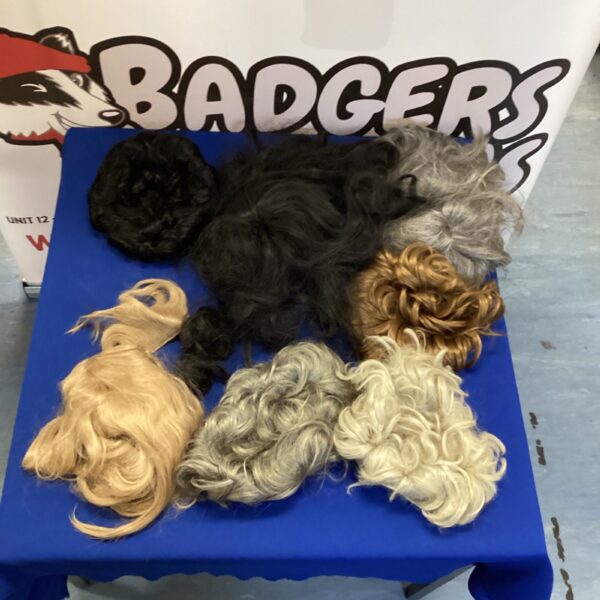 Mixed lot of colourful synthetic wigs for fashion and costumes.