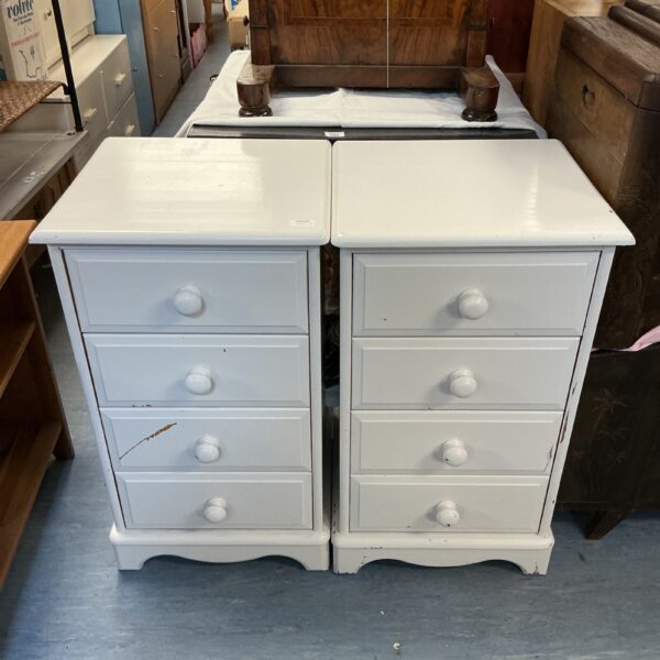 Pair of vintage painted pine bedside cabinets with four drawers.