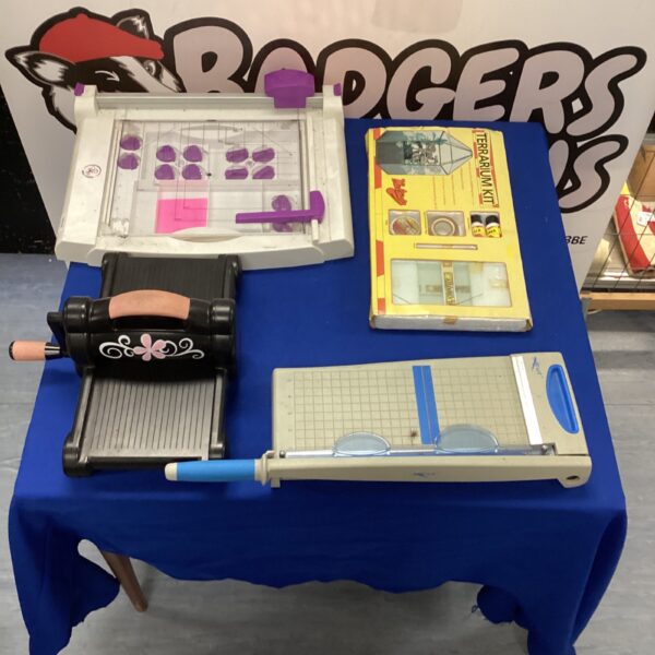 Paper trimmer lot with Sizzix Big Shot and terrarium kit for crafting.