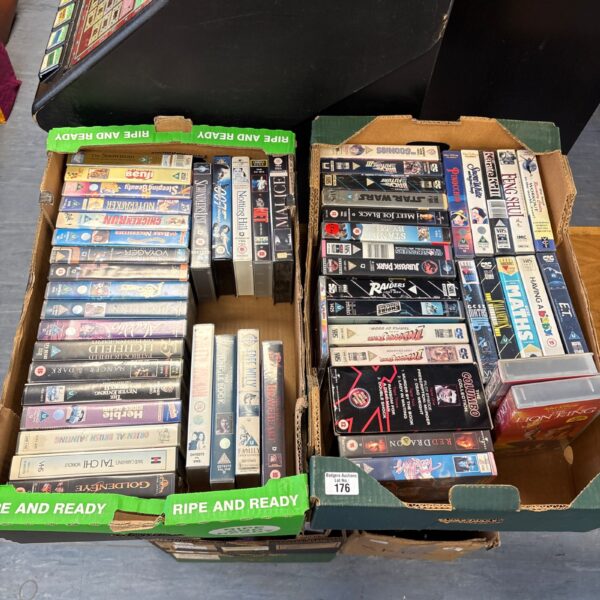 Two boxes of vintage VHS tapes for collectors.