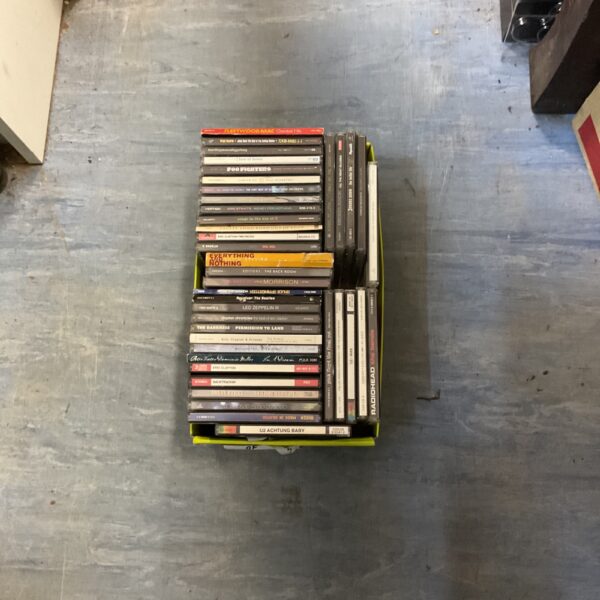 Stack of rock music CDs in a collection lot.