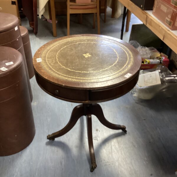 Vintage round leather top table with carved mahogany legs.