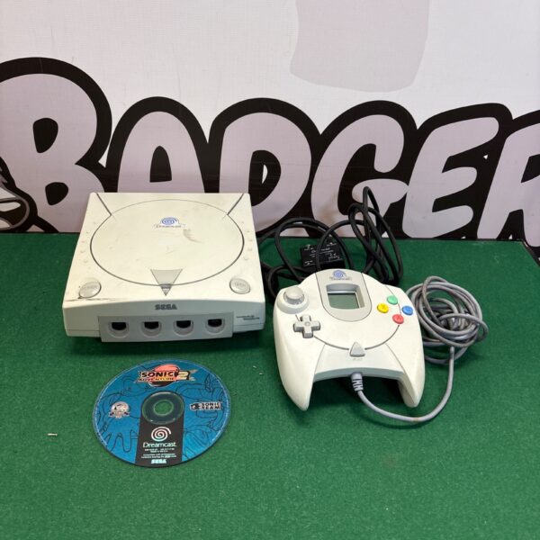 Sega Dreamcast console with controller and AV adapter for retro gaming.