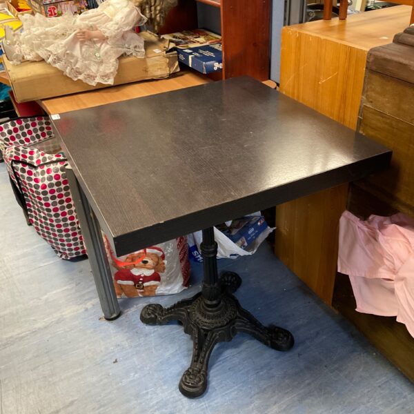 Vintage square pub table with cast iron claw feet.