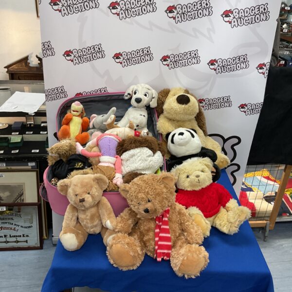 Vintage stuffed animal lot with pink suitcase.