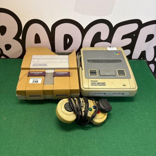 Two grey Super Nintendo consoles for repair and restoration.