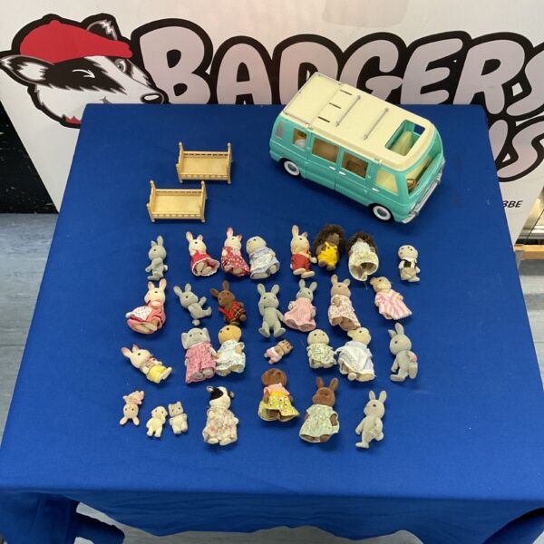 Vintage Sylvanian Families camper van with family figures displayed.