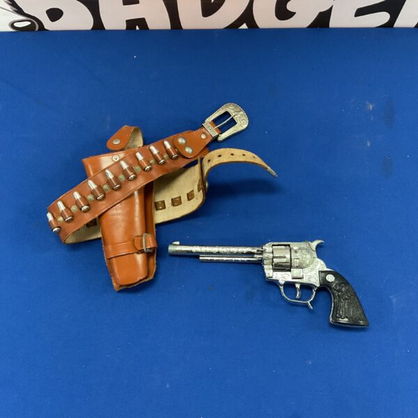 Vintage toy frontier gun set with brown holster.