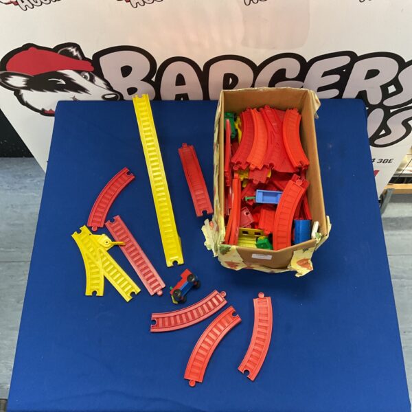Colourful plastic toy train track set with carriages.