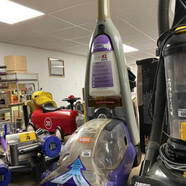 Used Vax carpet cleaner appliance with colourful toy cars nearby.