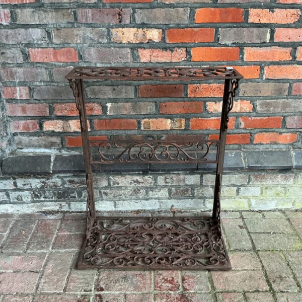 Intricate Victorian cast iron umbrella stand for hall decor.