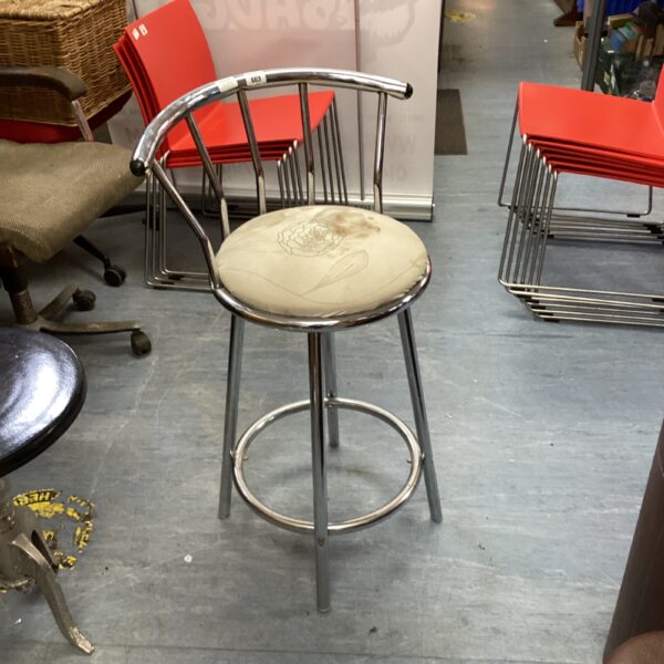 Vintage chrome swivel chair with light upholstery.
