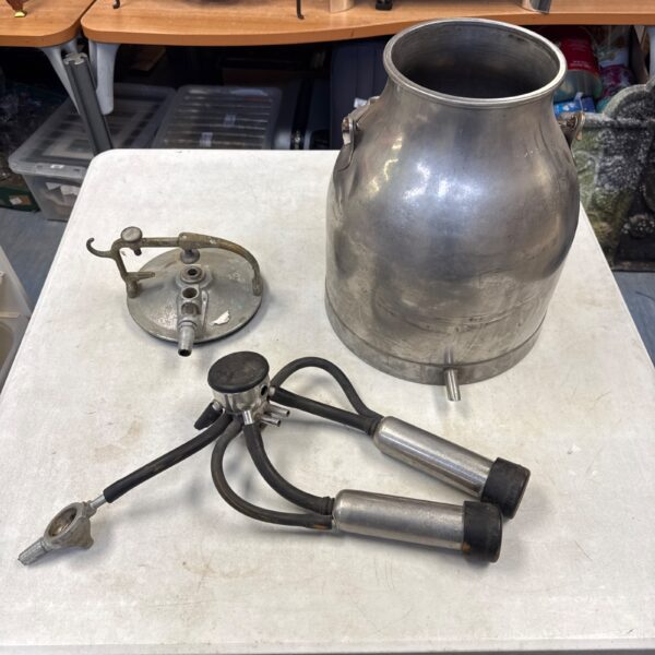 Vintage cow milking churn with attached mechanism.