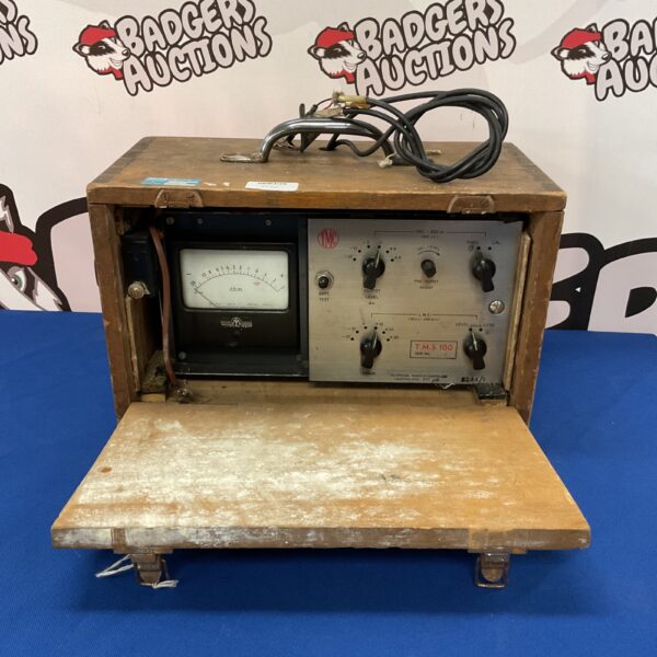 Vintage T M C decibel meter with dial display.