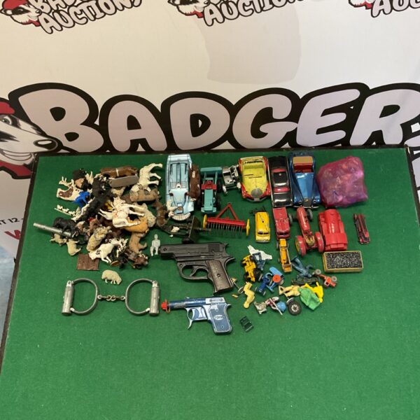 Overview of a vintage toy collection with diecast cars and farm animals.