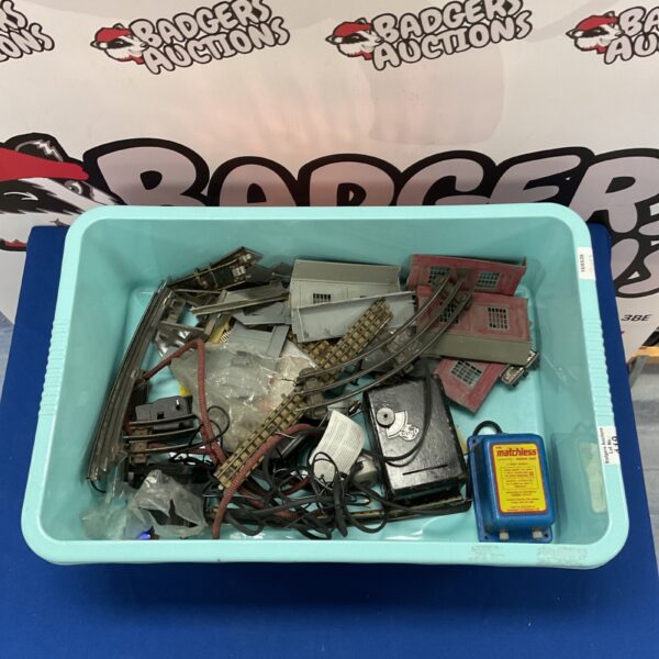 Vintage three rail train track collection with various pieces.